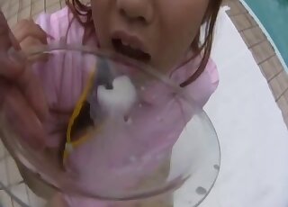 Japanese chick dressed in pink fucks a black animal by the pool